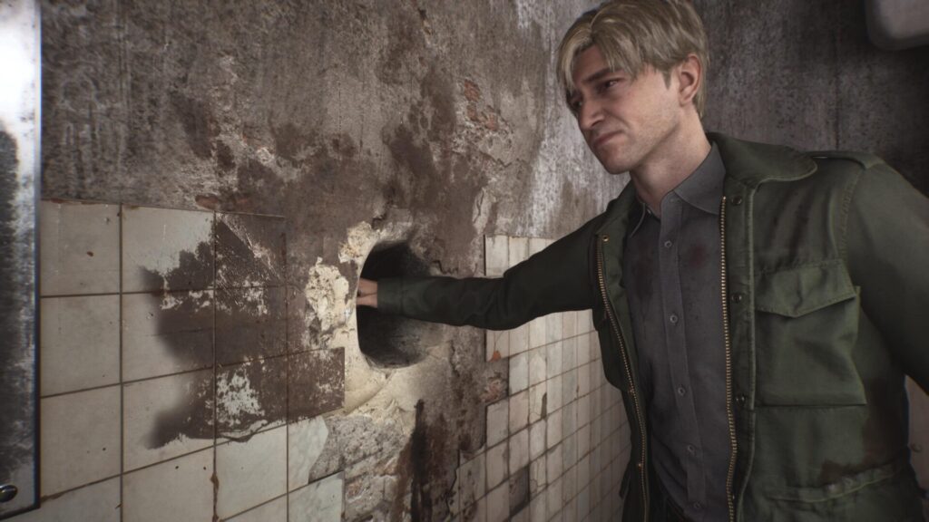 James Sunderland met sa main dans un trou peu recommandable dans Silent Hill 2