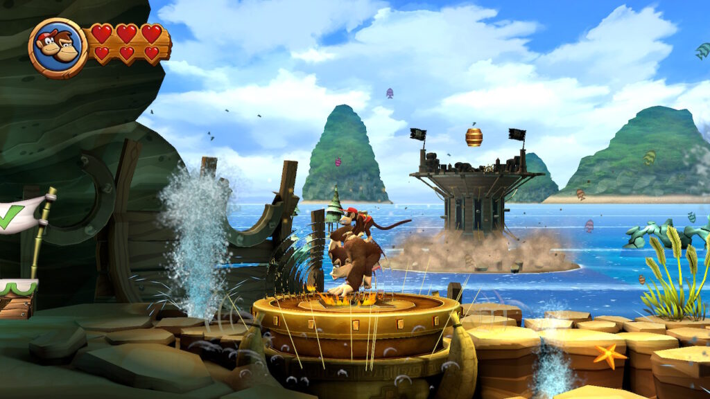 Donkey Kong tape sur le sol, ce qui fait sortir un pilier au second plan dans Donkey Kong Country HD Returns