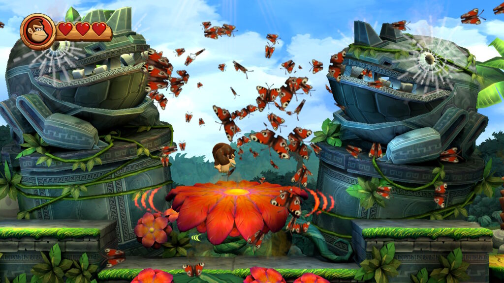 Donkey Kong saute sur une fleur et des papillons s'envolent dans Donkey Kong Country HD Returns