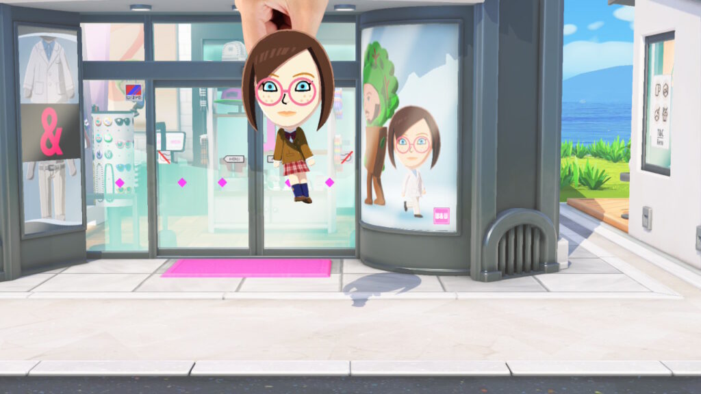 La main du créateur qui prend un personnage dans Tomodachi Life